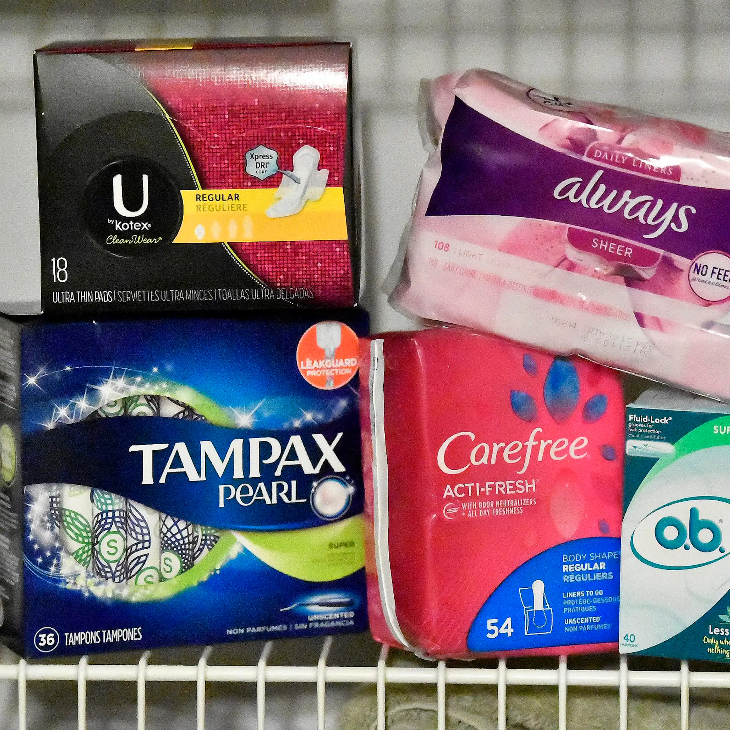 A selection of tampons and pads on a shelf