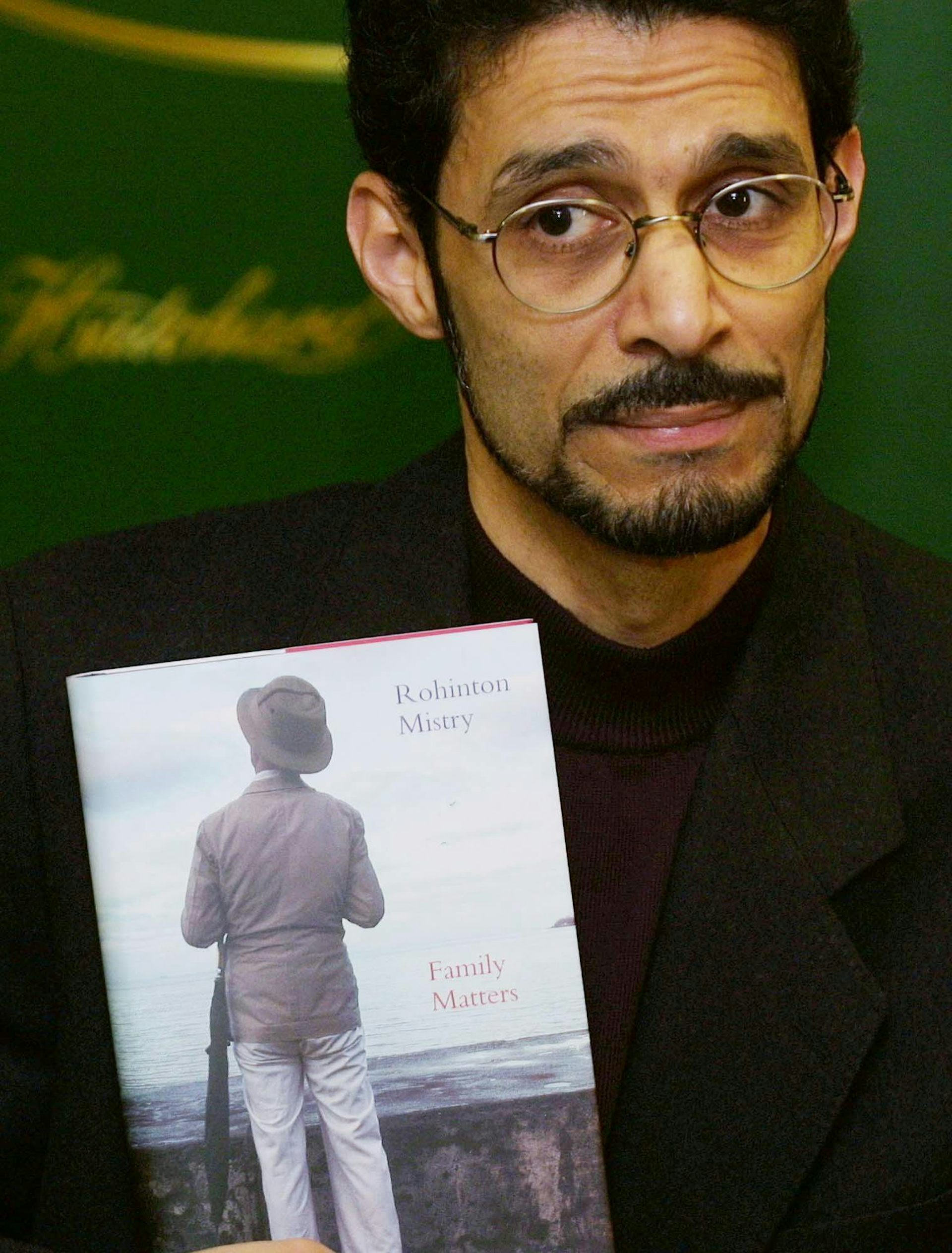 A man poses with a book.