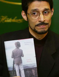 A man poses with a book.