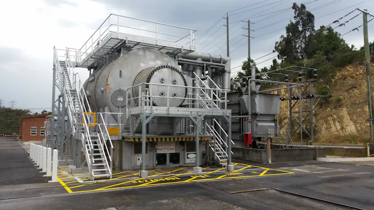large electrical machine with asphalt surrounding it.