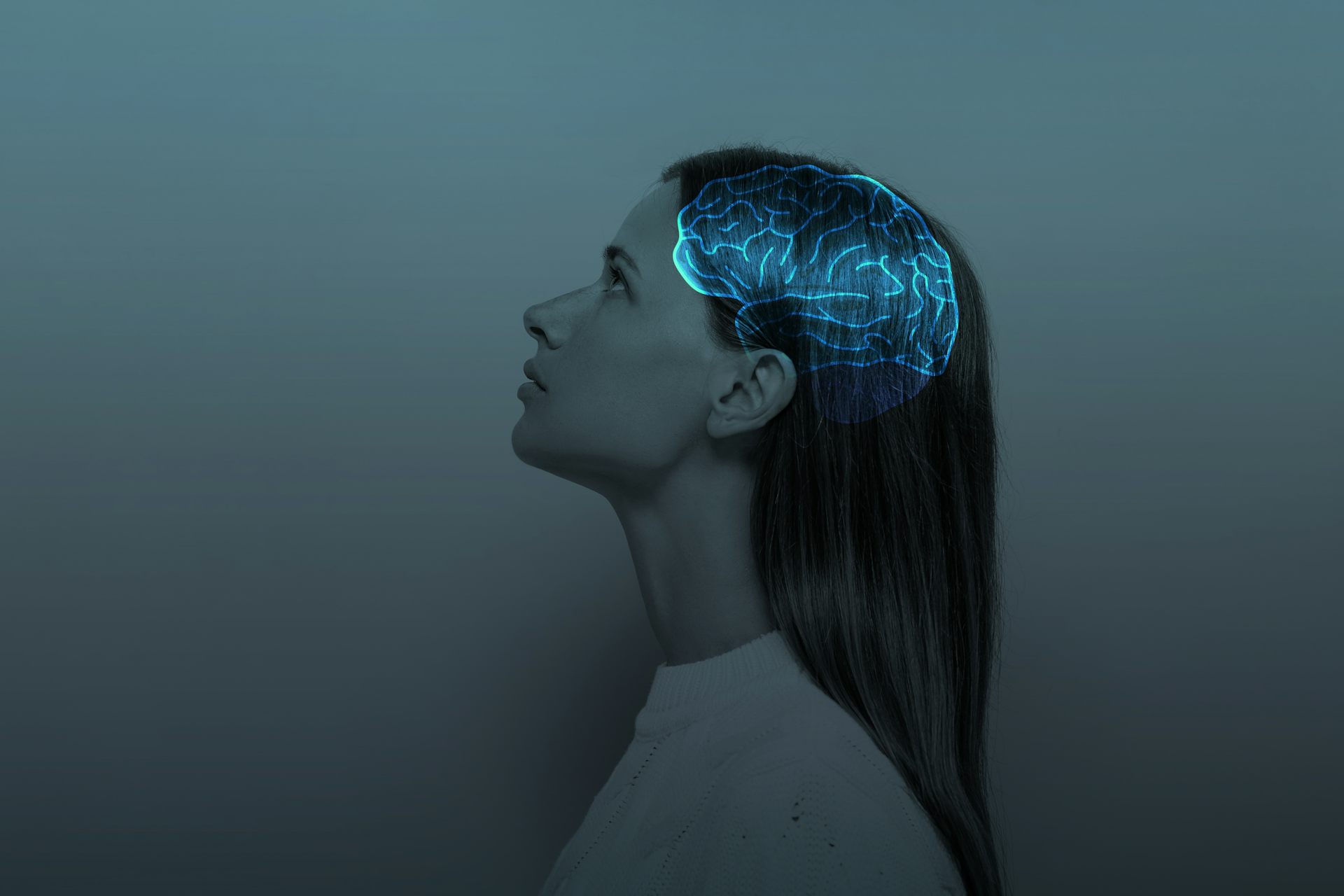 Image of woman from profile view overlayed with glowing brain