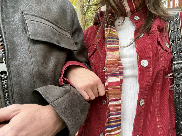 Two people linking arms dressed in a Y2K style