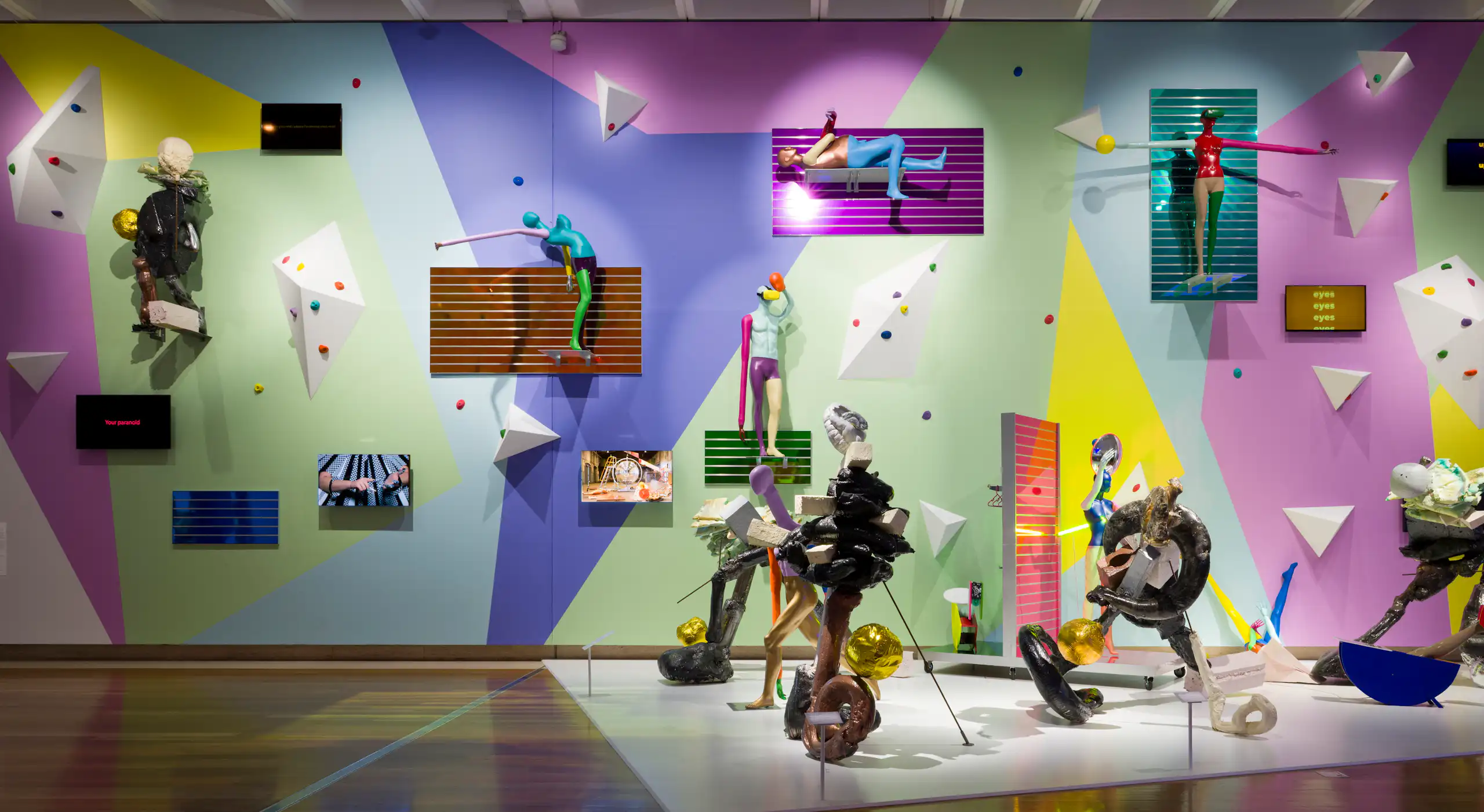 A colourful wall of crazy objects and mannequins.