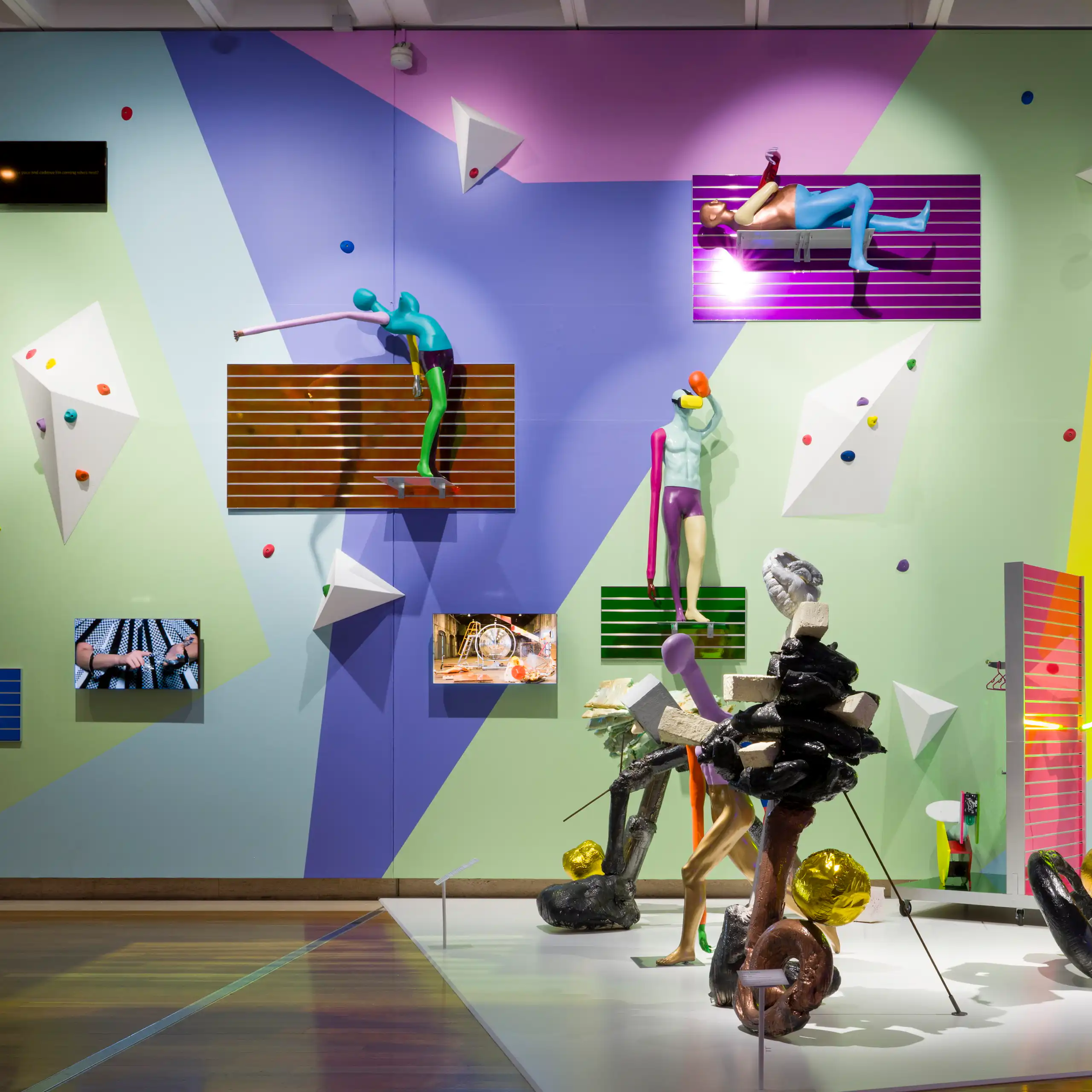A colourful wall of crazy objects and mannequins.