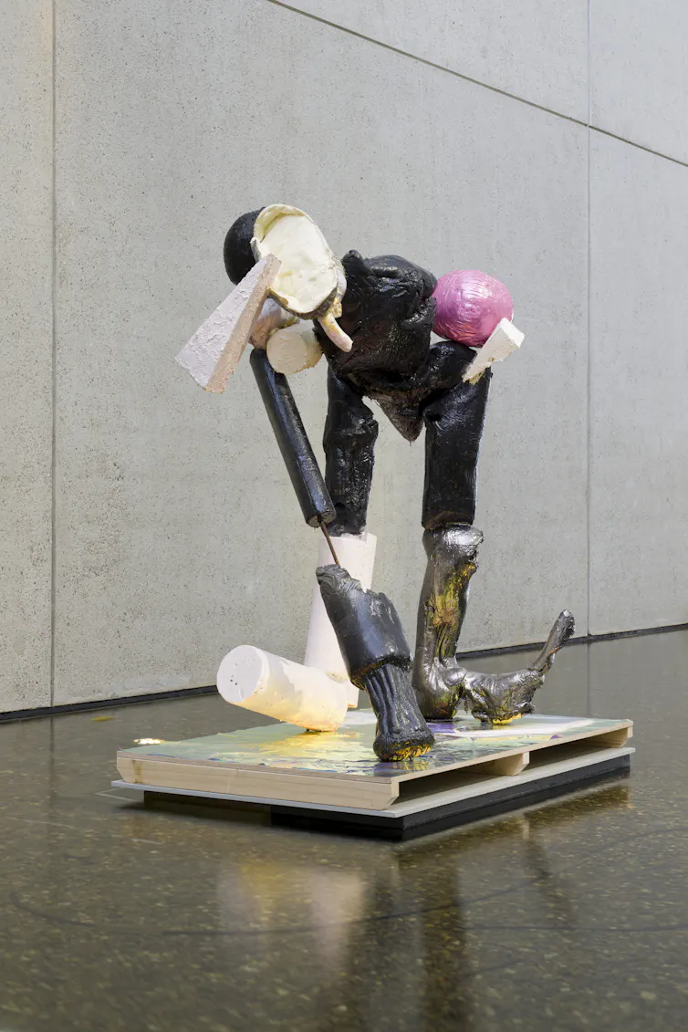 A weird human-ish sculpture of found objects.
