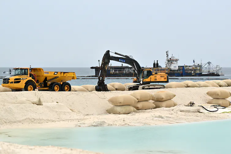 Heavy machinery at a land reclamation site on the edge of the sea in Funafuti, Tuvalu.