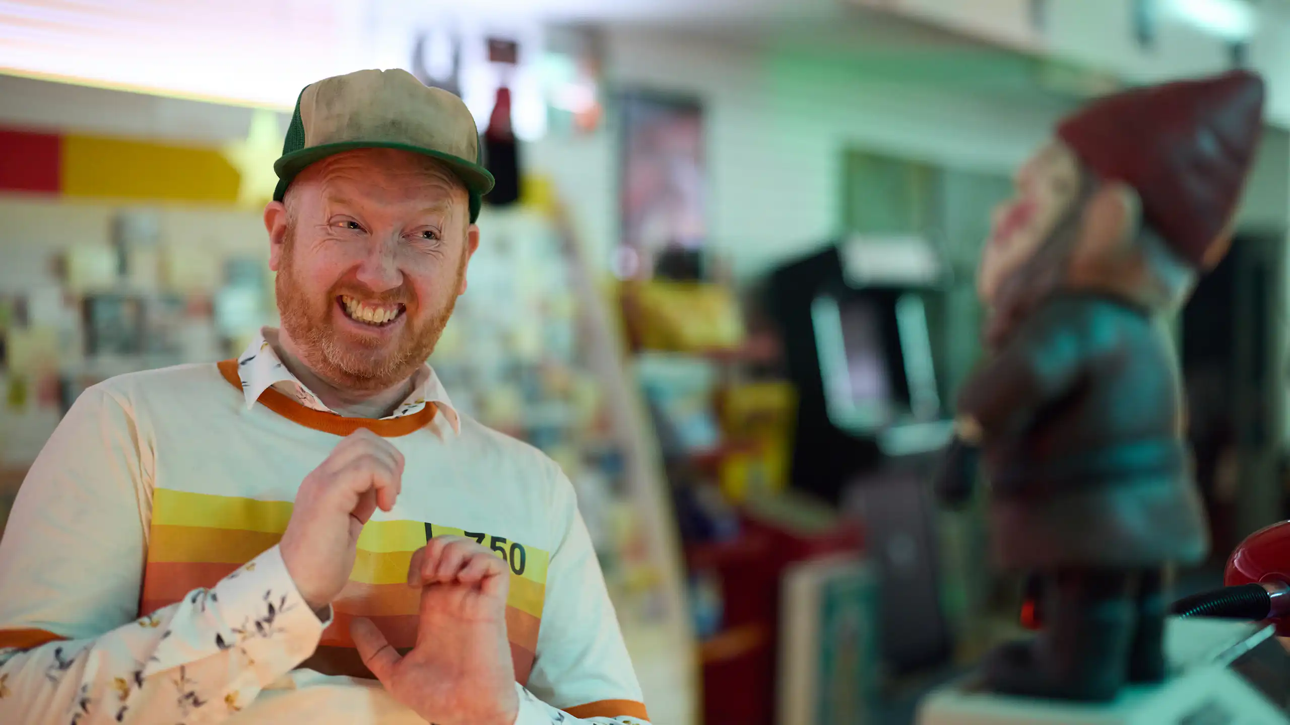 Luke McGregor pulls an awkward face at a gnome.