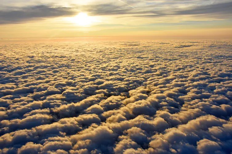 Sun shines on the tops of a blanket of clouds