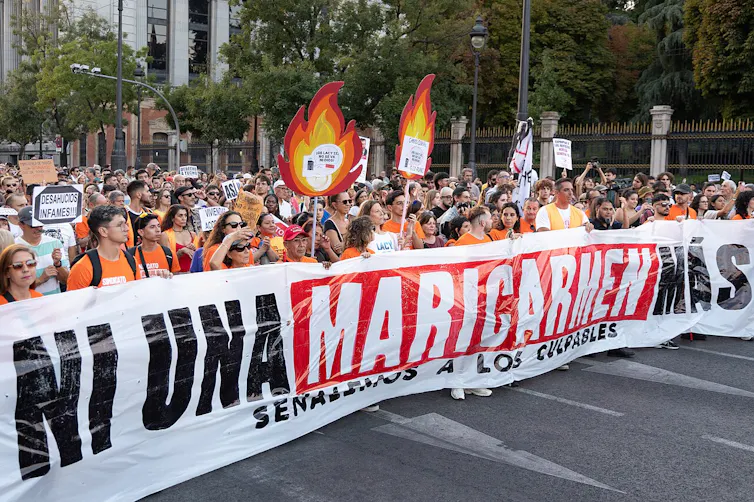 Demonstrators hold a banner that reads: Ni una Maricarmen más. Señalemos a los culpables ('Not one more Maricarmen. Let's point out the guilty')
