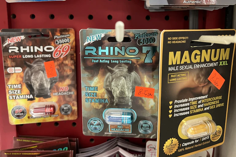 packages of sexual enhancement drugs hanging in a convenience store