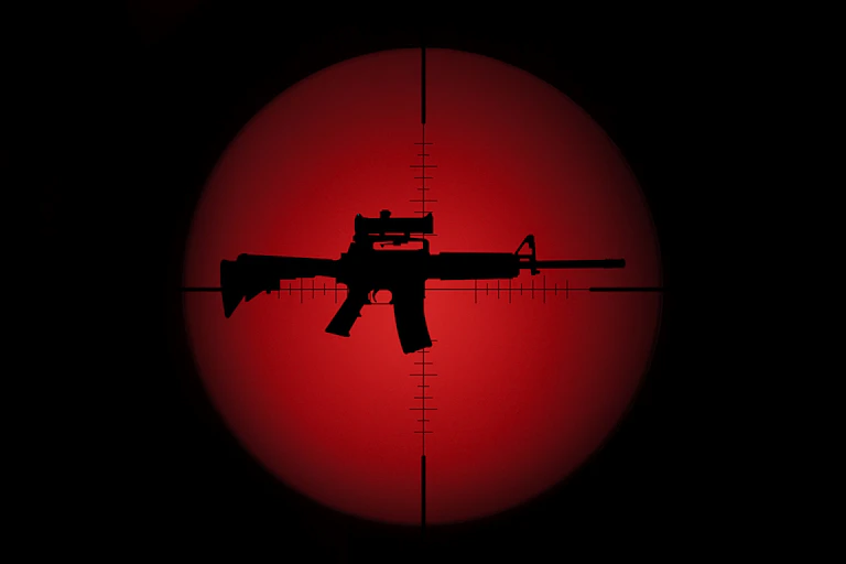 An image of an assault rifle in crosshairs with a red background.