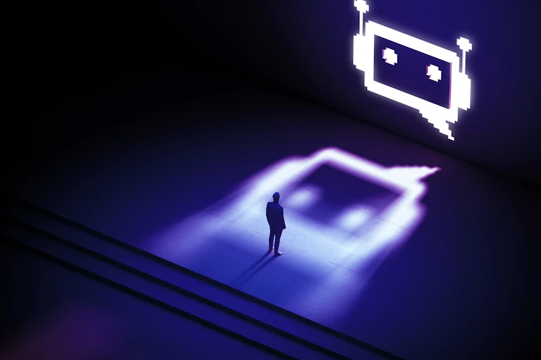 An ominous digital robot face looming over a small silhouette of a person.