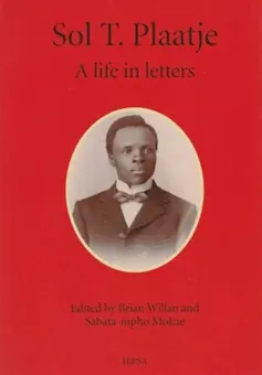 A red book cover with a black and white portrait of an African man in a suit and bowtie.