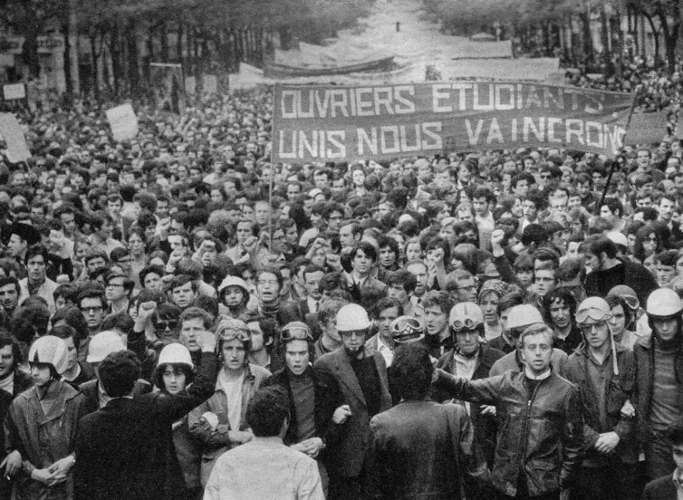 A crowd of young people on a Paris street in 1968.