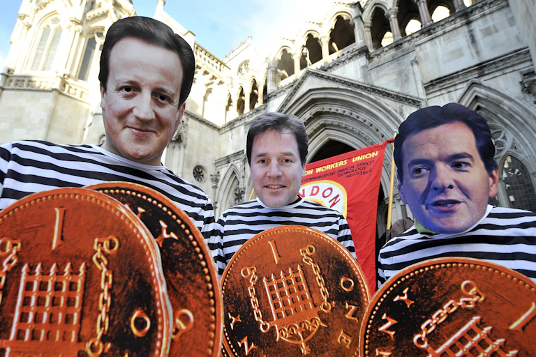 Pension cut protestors in 2011 wearing masks of David Cameron, Nick Clegg and George Osborne
