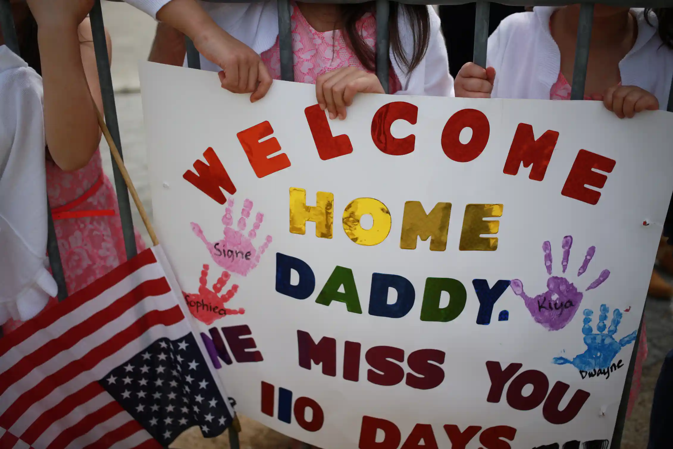 A sign next to an American flag says,