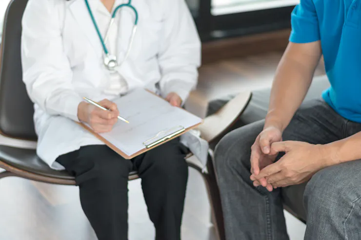Doctor sitting with male patient