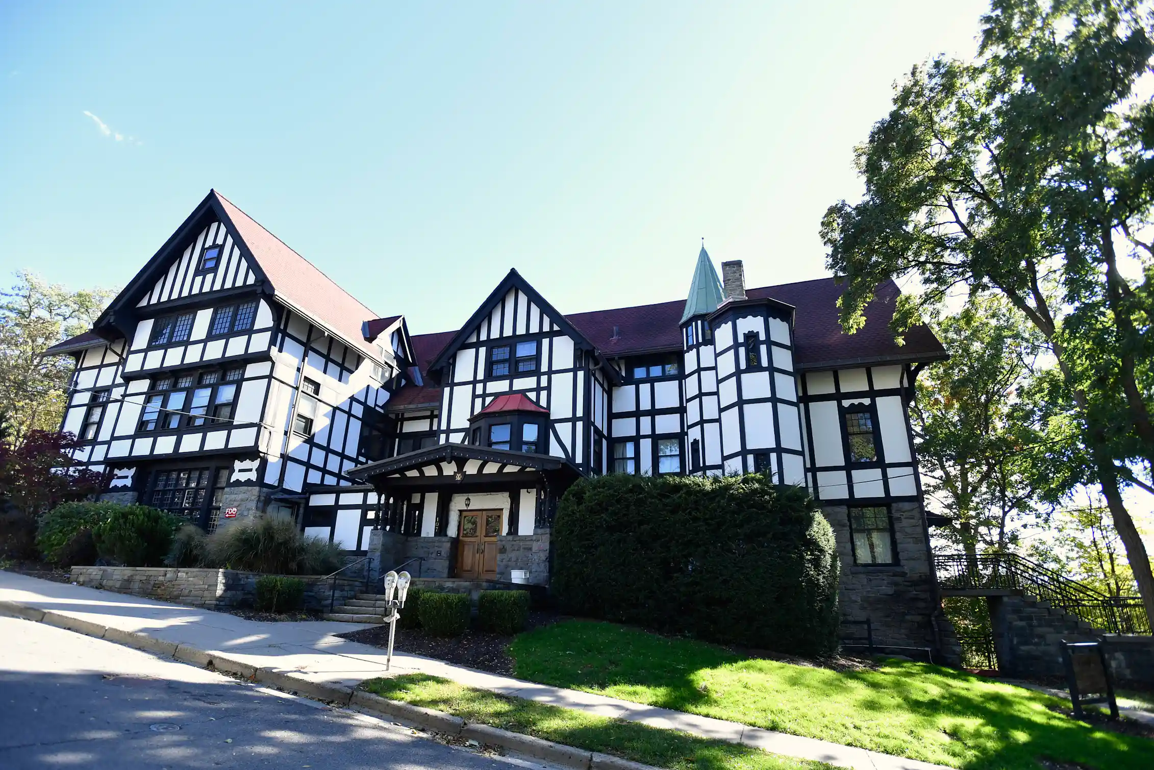 An immense Tudor-style building looms on a hill