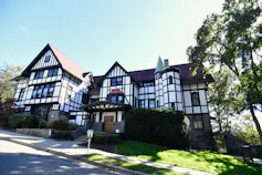 An immense Tudor-style building looms on a hill