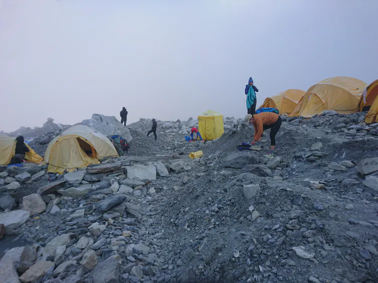 A group of mountaineers stand beside their tents at Mount Everest base camp in Nepal.