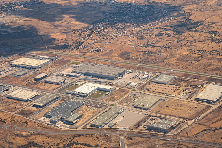 Aerial view of industrial buildings in the desert.