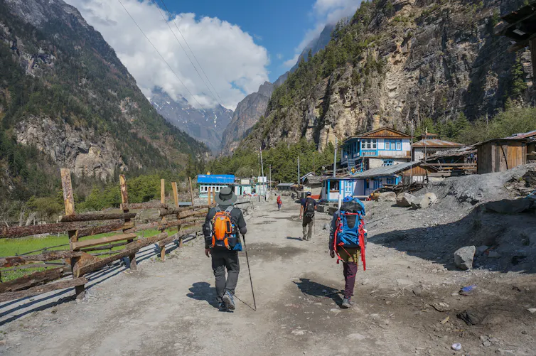 People on a trek in narrow Nepal valley