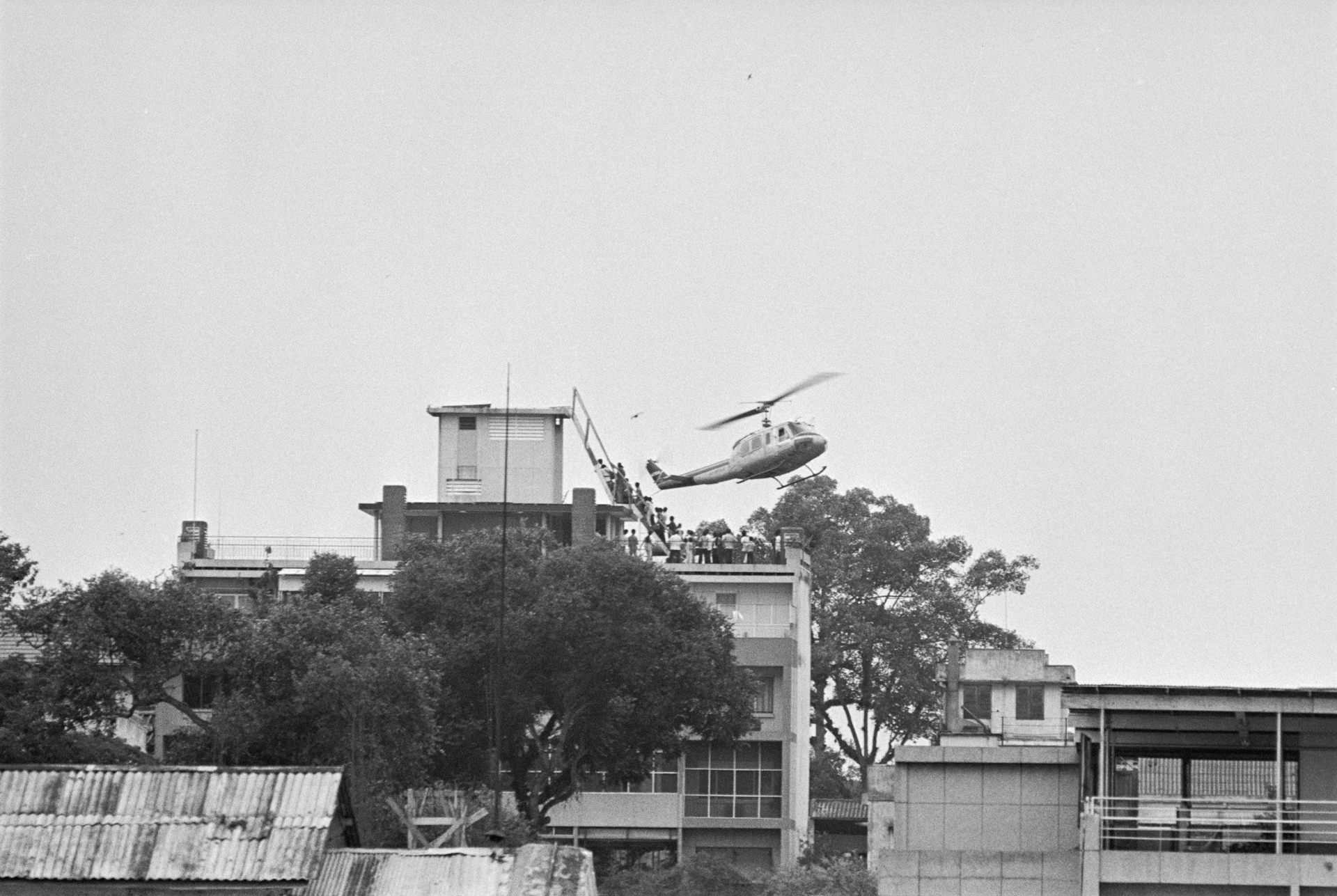 A helicopter is seen hovering over a building.