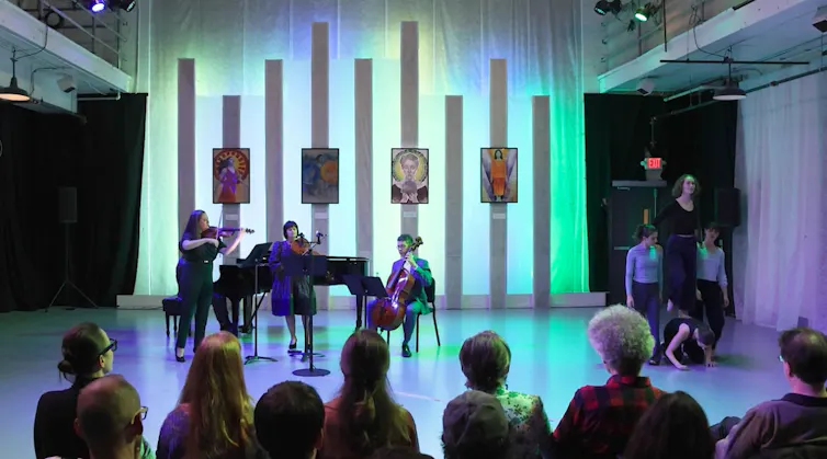 A quartet performs alongside dancers.