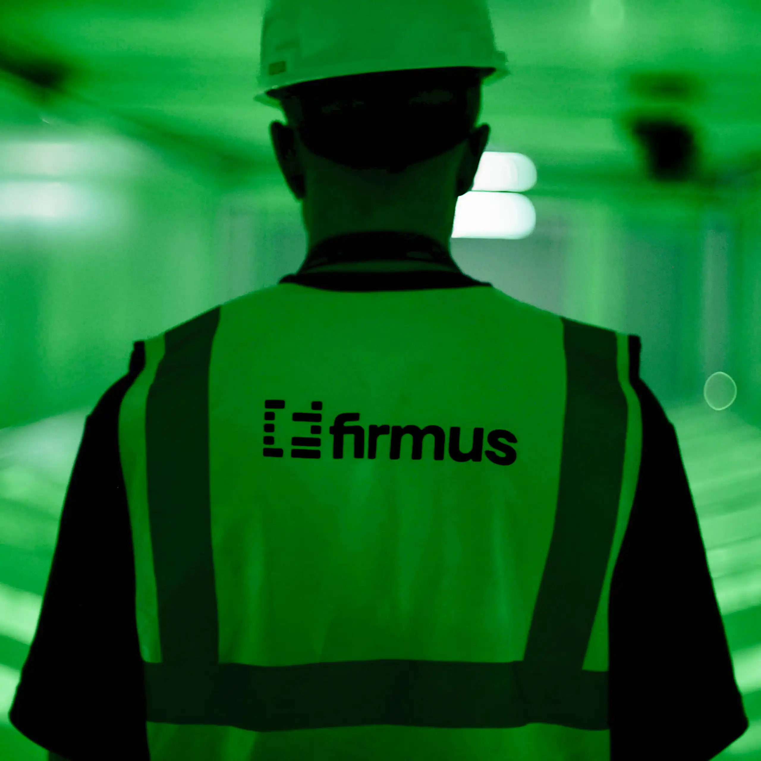 A man in a Firmus high vis vest and helmet