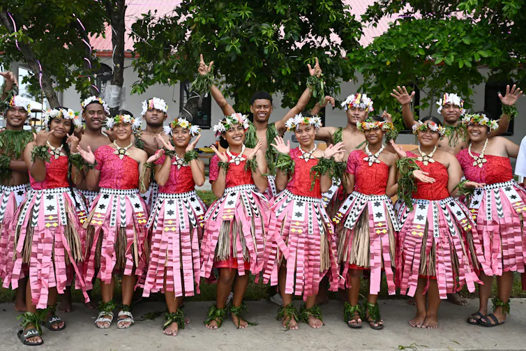 Students in colourful cultural dress pose outside the venue for the Pacific Pre-COP31 leaders event in Funafuti, Tuvalu.