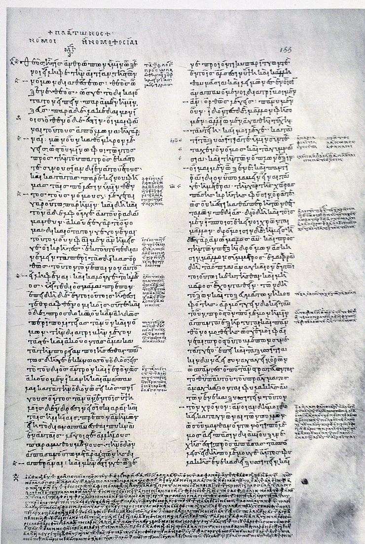A manuscript page with two columns, and small notes printed in the margins.