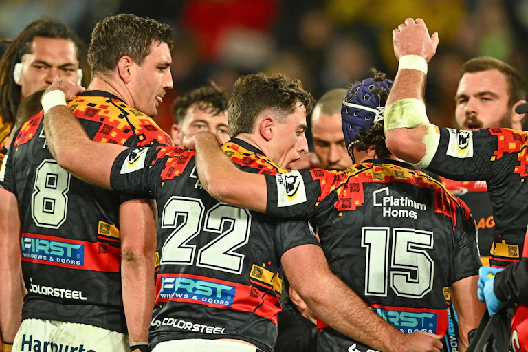 Chiefs players huddle during the Super Rugby Pacific final against the Wellington Hurricanes.
