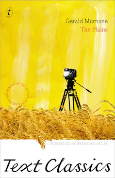 book cover: The Plains - a yellow cover with a camera on a tripod in a wheat field