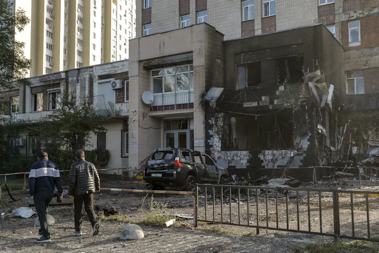 Local residents walk past the site of a Russian strike on a coffee shop in a residential area of Kyiv, Ukraine, 28 September 2026