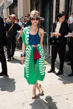 Catherine Baba in Paris wearing green striped clothing