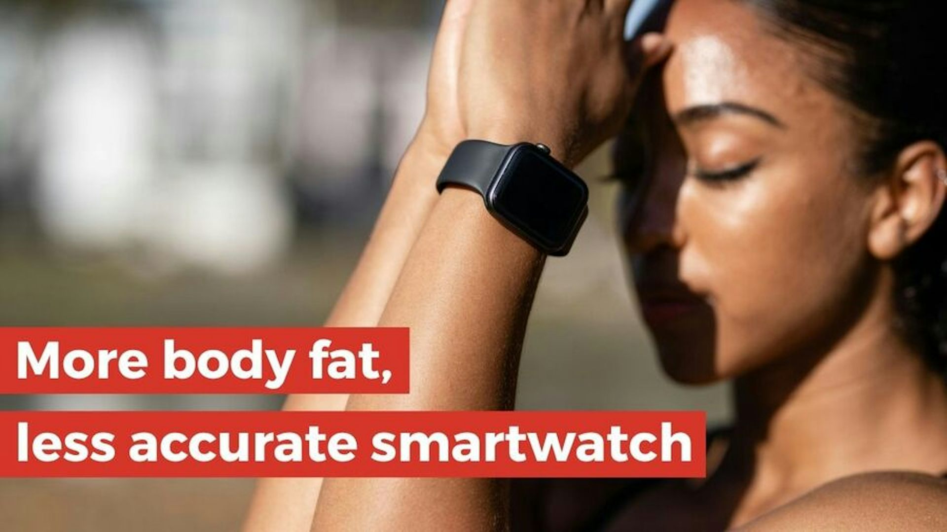 Woman wearing a black smartwatch with her eyes closed, appearing to meditate.