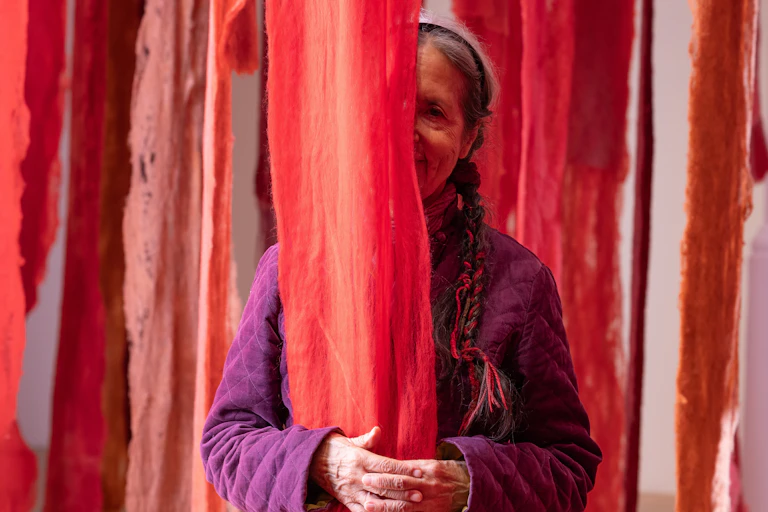 Cecilia Vicuña with her work at Whitechapel Gallery.