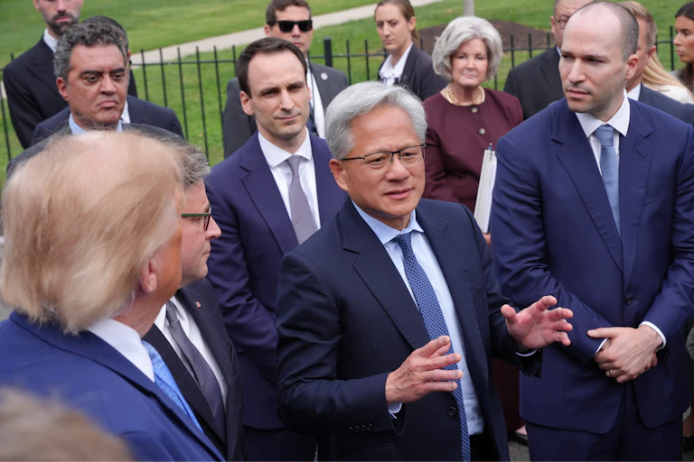 Nvidia chief executive Jensen Huang, centre, speaking at the White House. OpenAI president Greg Brockman is on the right.