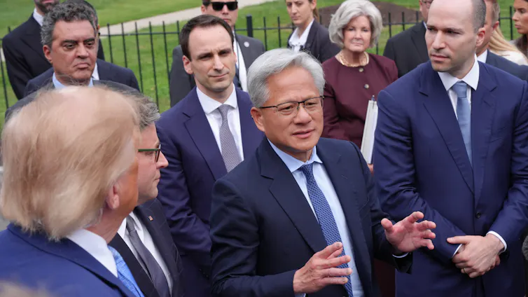 Nvidia chief executive Jensen Huang, centre, speaking at the White House. OpenAI president Greg Brockman is on the right.