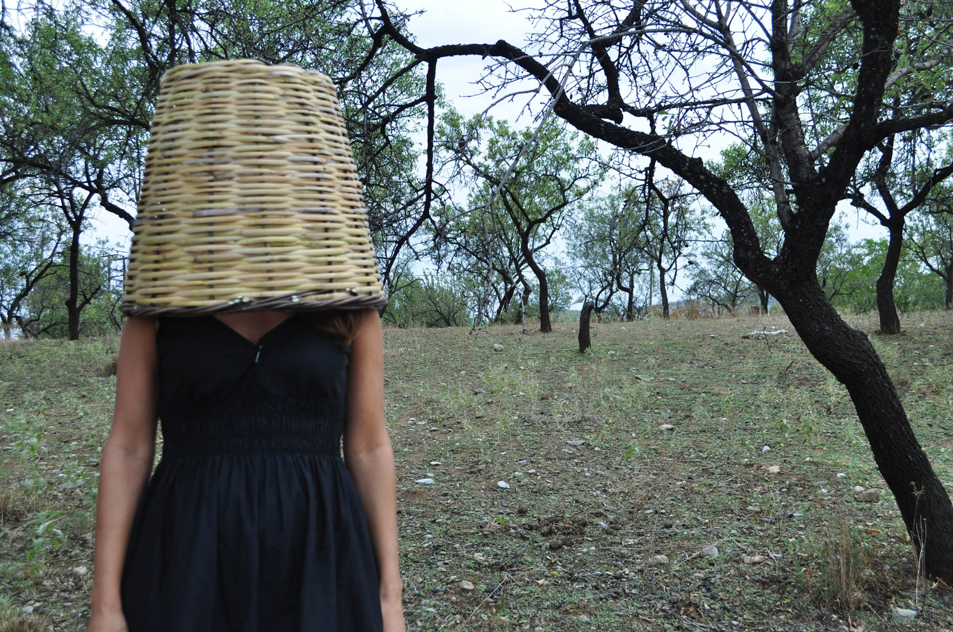 Giannisi covering her head with a woven basked