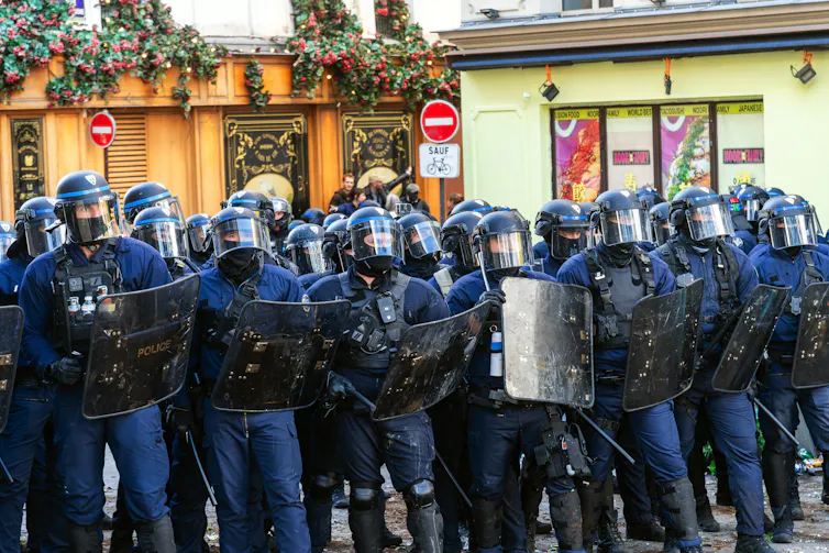 Line of police in riot gear
