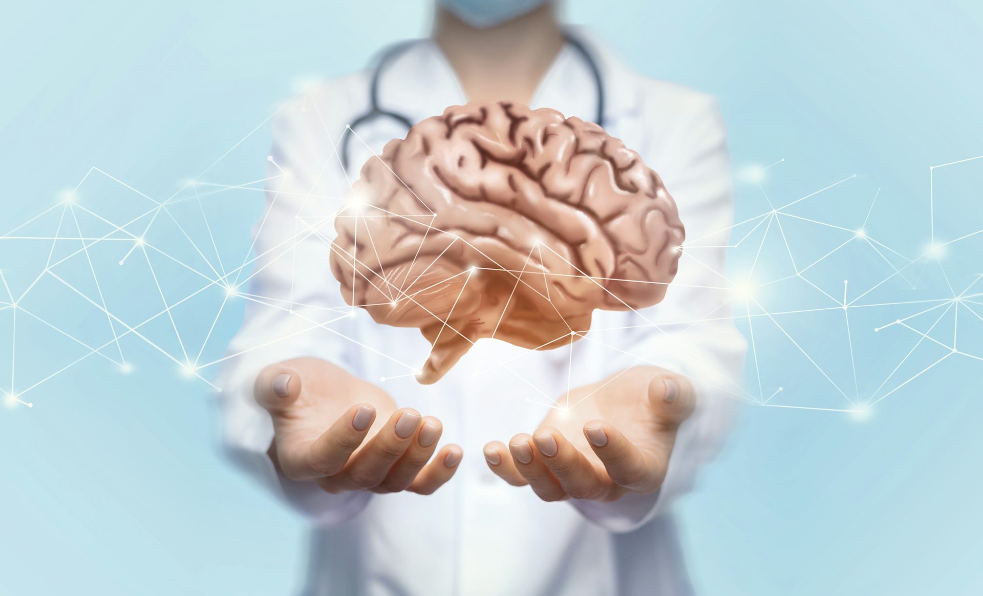 Concept illustration of brain floating above doctor's hands