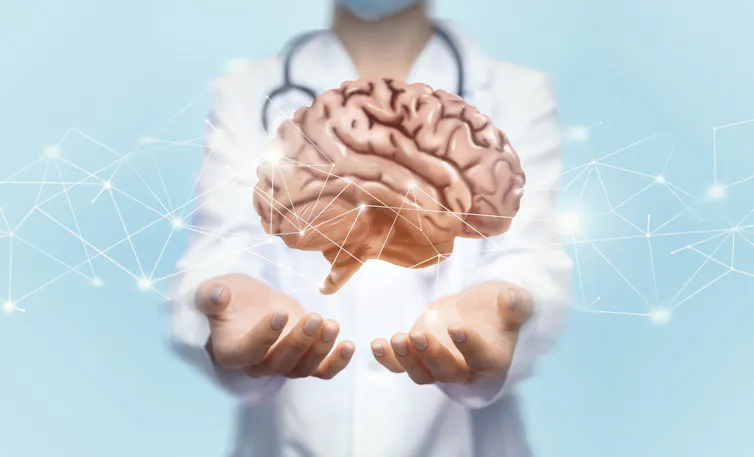 Concept illustration of brain floating above doctor's hands