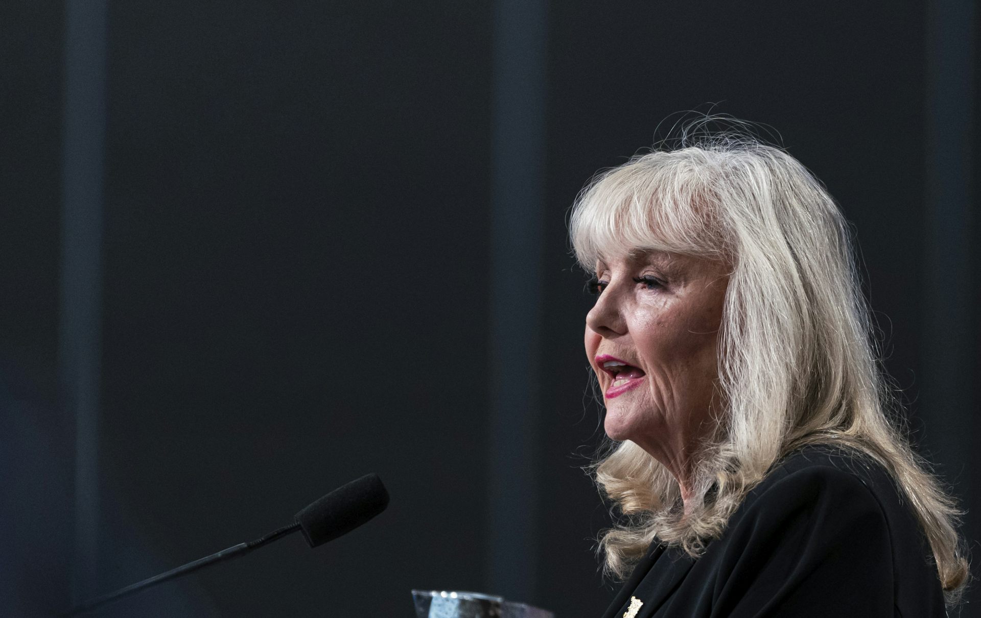 An older woman with long grey hair and bangs.