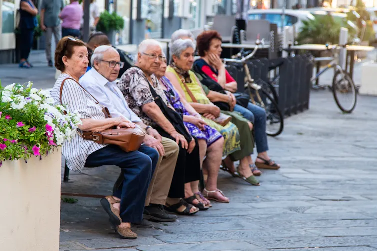 Pensioners sitting on a bench in La Spezia, Italy.