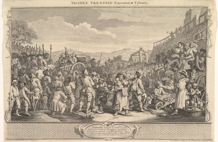 A crowd of people in an 18th century scene of a public hanging.