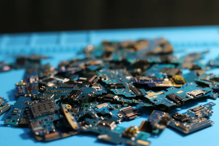 A pile of computer chips against a blue background.