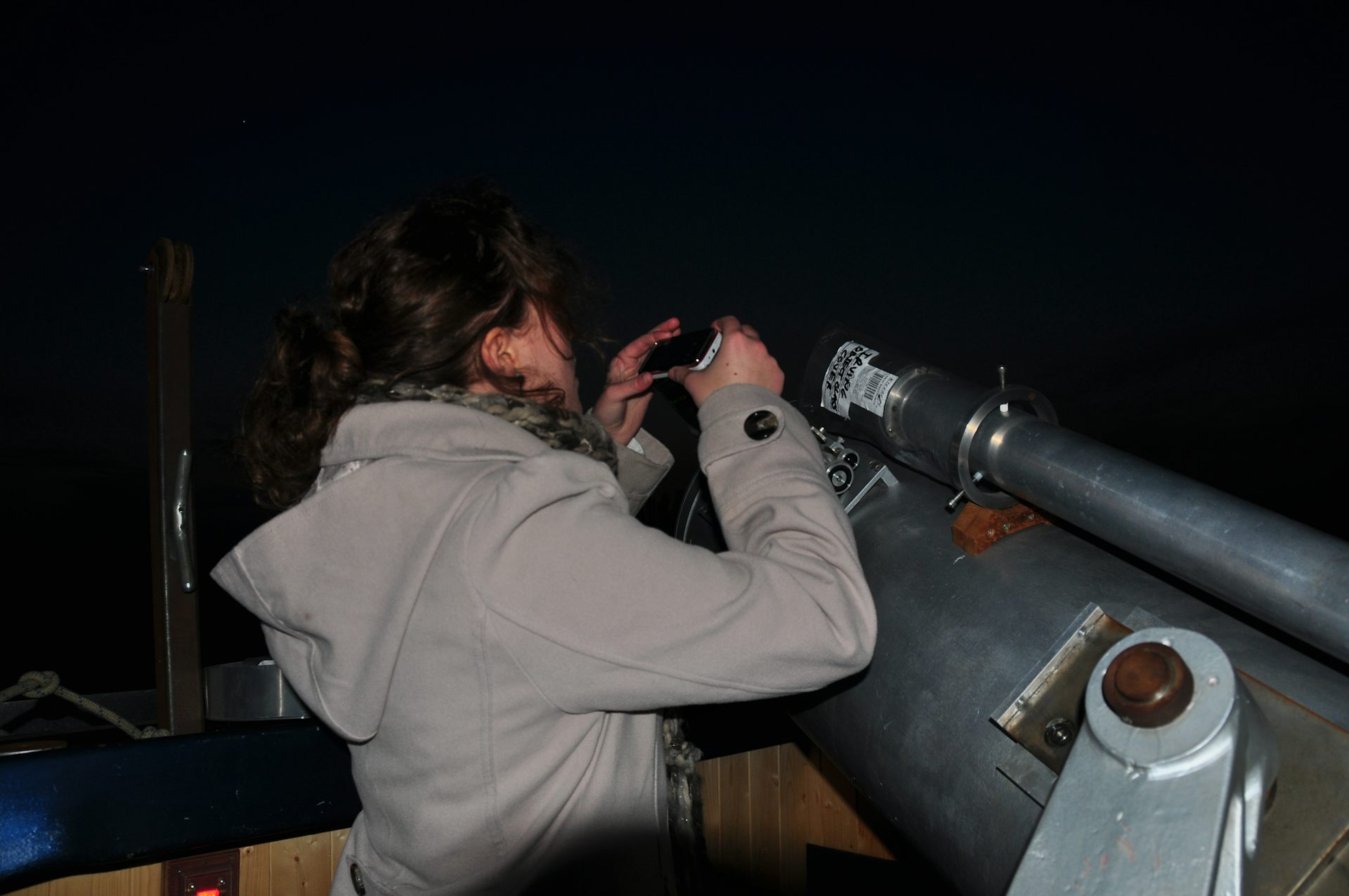 Woman looking into telescope.