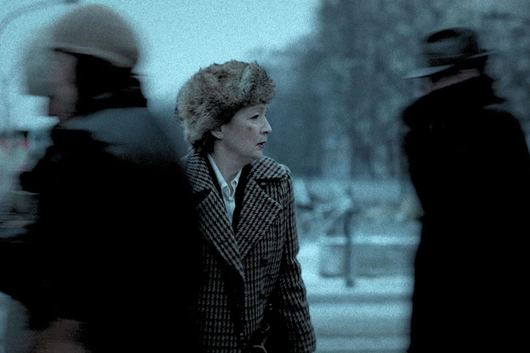 Lesley Manville as Professor Joan Andrews in a fur hat on a snowy street.