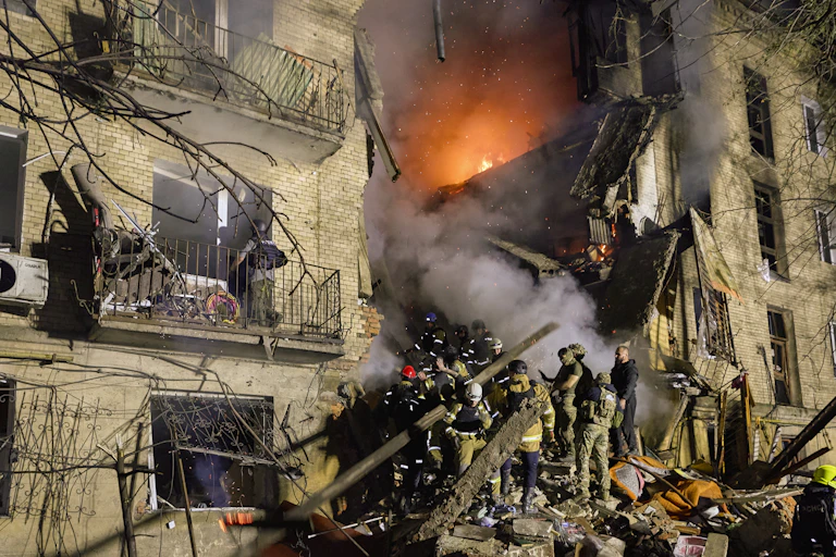 Fiirefighters at the scene of a Russian strike on an apartment building in Kharkiv.